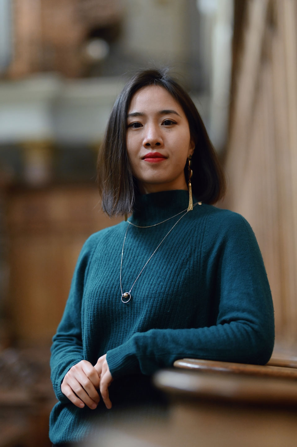 Wanying Ling inside a church. The organ is blurred in the Background.